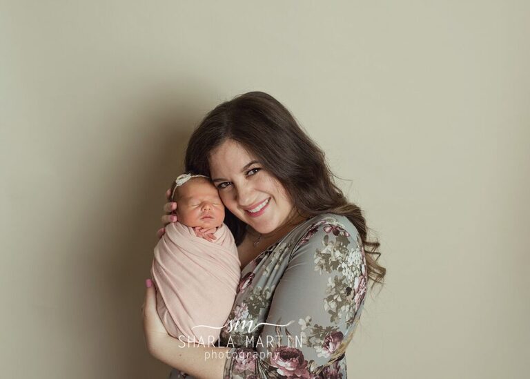 mom holding newborn baby girl
