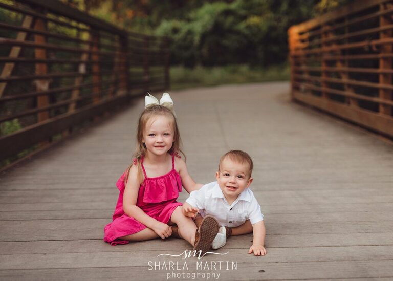 one year baby with sister on bridge in cedar park