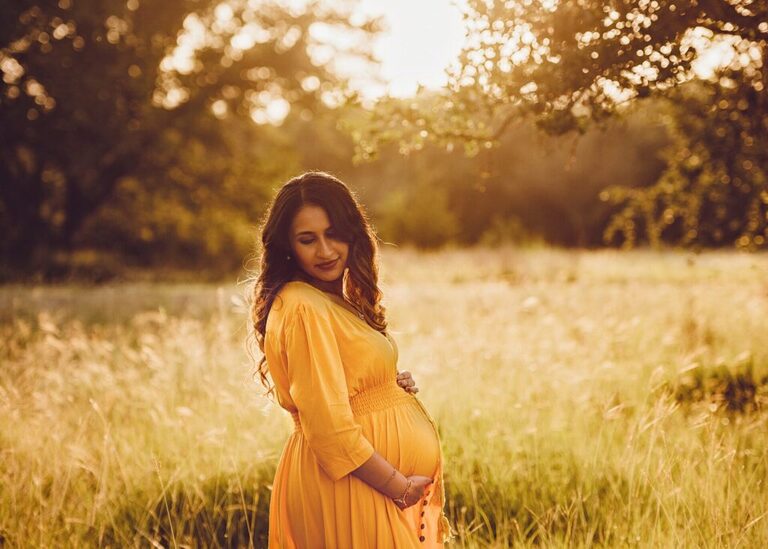 pregnant mom taking maternity pictures in georgetown field