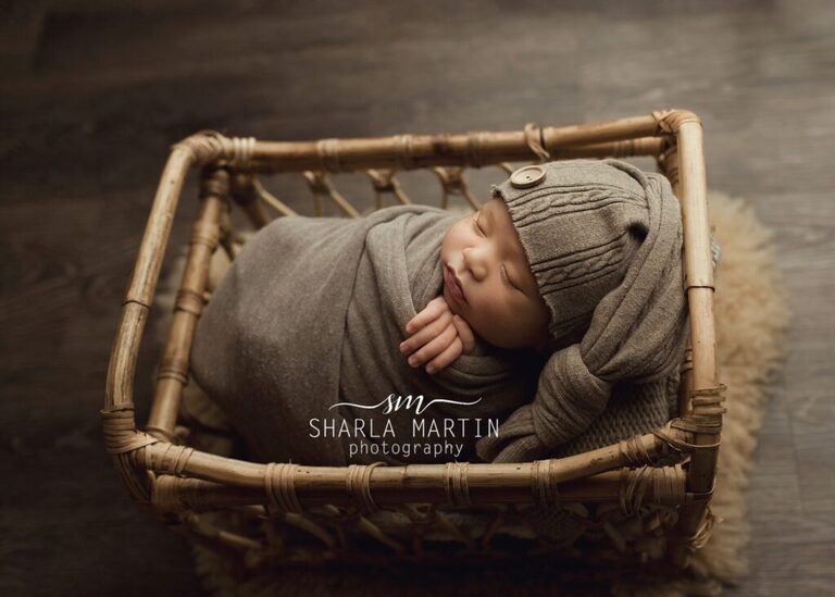 Newborn posed in bed basket for baby photos austin