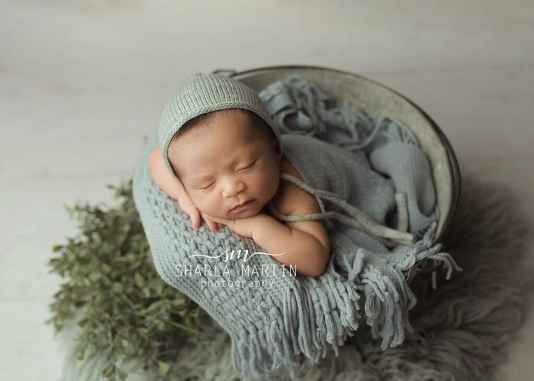 Newborn baby boy posed in tin bucket for newborn photography
