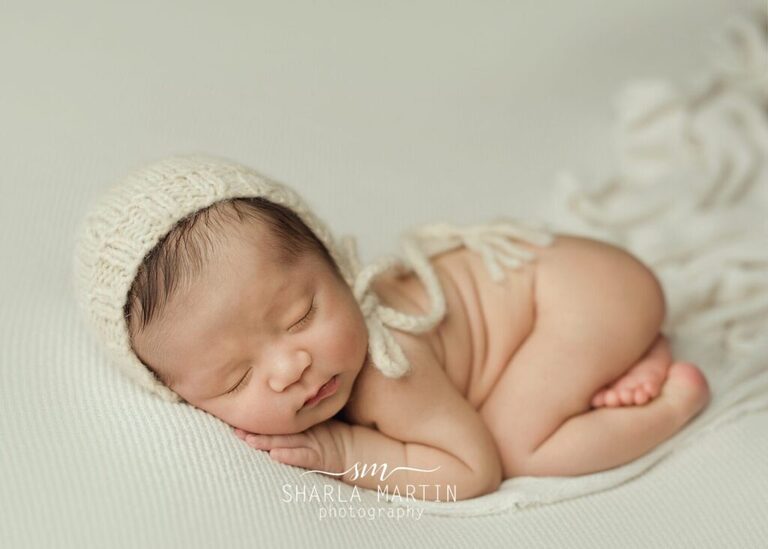 newborn baby boy posed for newborn photos sleeping in bum up pose