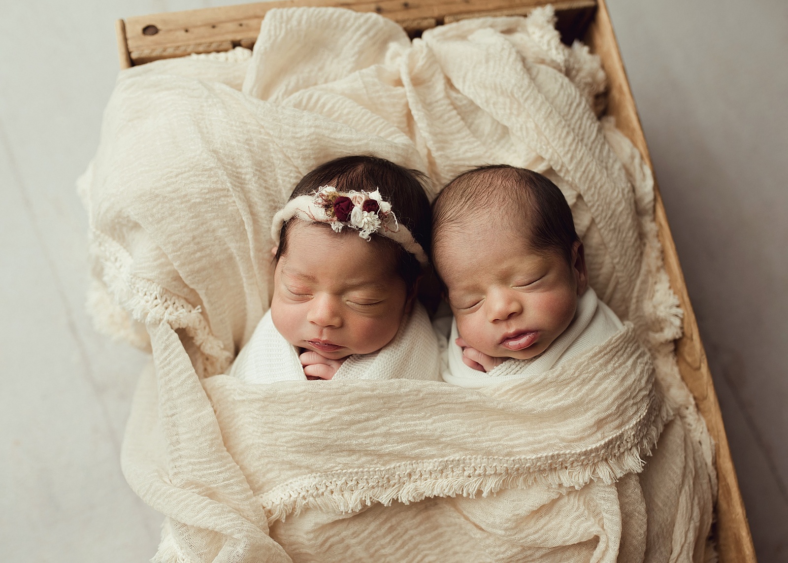 twin girl and boy posed in crate